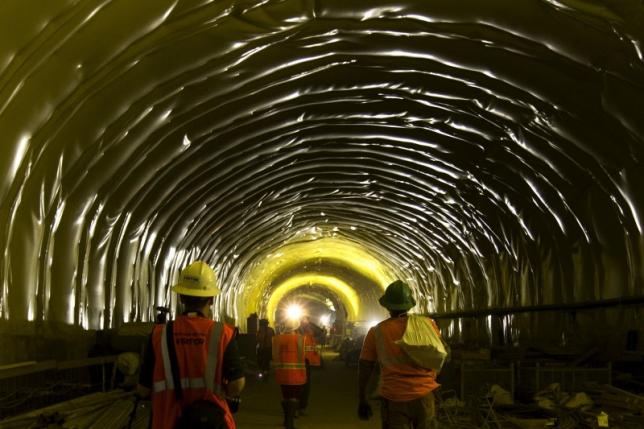 Media and workers walk in a tunnel in the East Side Access project is seen during a media tour of the site in New York, November 4, 2015. REUTERS/Mike Segar